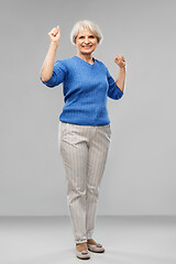 Image showing portrait of happy senior woman celebrating success