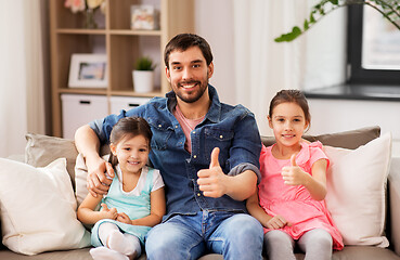 Image showing father with daughters showing thumbs up at home