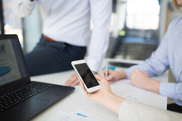 Image showing business team with smartphone working at office