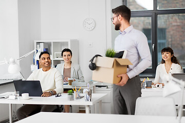 Image showing happy male office worker with personal stuff