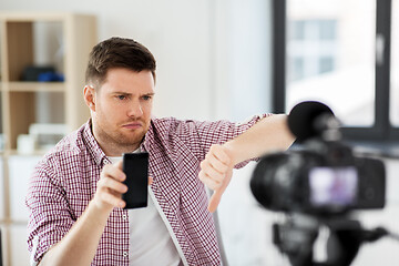 Image showing male blogger with smartphone videoblogging at home