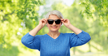 Image showing smiling senior woman in black sunglasses