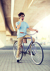 Image showing man with smartphone and fixed gear bike on street