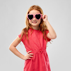 Image showing smiling red haired girl in heart shaped sunglasses