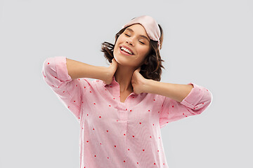 Image showing happy young woman in pajama and eye sleeping mask