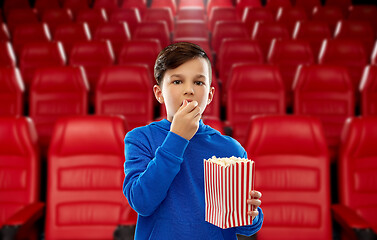 Image showing boy in blue hoodie eating popcorn at movie theater