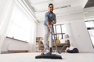 Image showing indian man with vacuum cleaner at home