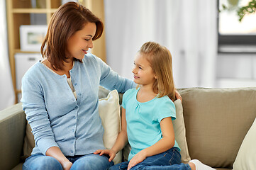 Image showing mother and daughter looking at each other at home