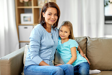 Image showing mother and daughter sitting on sofa at home