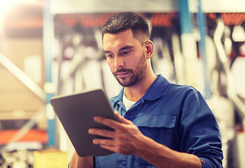 Image showing auto mechanic or smith with tablet pc at workshop