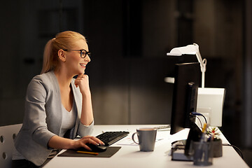 Image showing businesswoman at computer working at night office