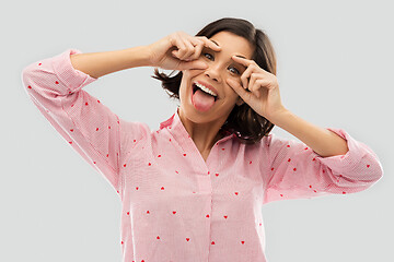 Image showing happy young woman in pajama opening her eyes