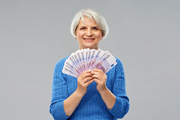 Image showing senior woman with hundreds of euro money banknotes