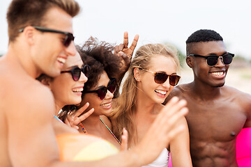 Image showing happy friends in sunglasses on summer beach