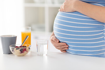 Image showing close up of pregnant woman touching her belly