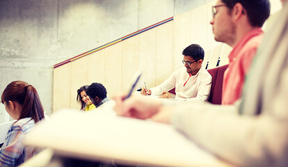 Image showing group of students with notebooks in lecture hall