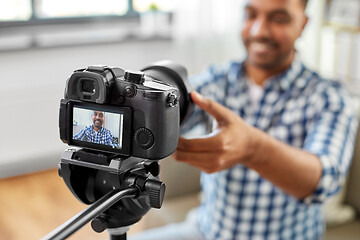 Image showing close up of indian video blogger adjusting camera