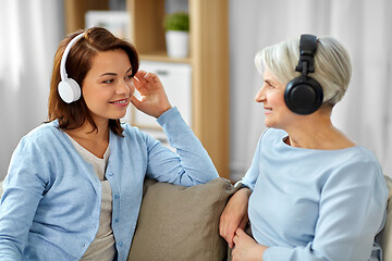 Image showing senior mother and adult daughter with headphones