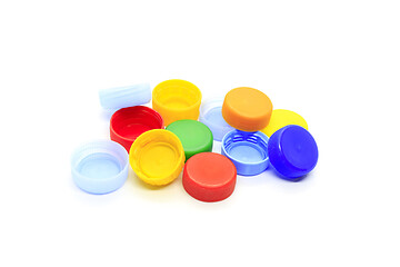 Image showing Multicolored caps from plastic bottles on white background