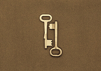 Image showing Two old metal keys on paper background