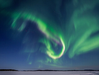 Image showing Green and Pink Aurora Borealis over Lake Inari