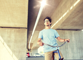 Image showing young hipster man riding fixed gear bike