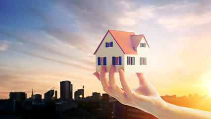 Image showing close up of hand holding house or home model