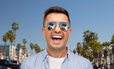 Image showing laughing man in sunglasses over venice beach