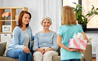 Image showing grandmother, mother and daughter with gift box