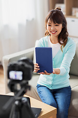 Image showing asian female blogger making video review of book