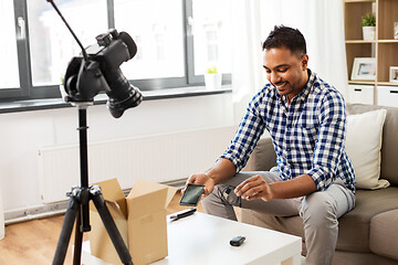 Image showing male blogger with smartphone, wire and parcel box