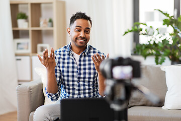 Image showing male blogger with camera videoblogging at home