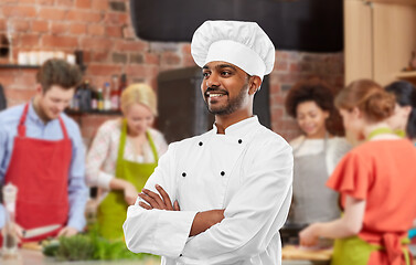 Image showing happy male indian chef in toque at cooking class