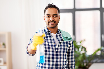 Image showing smiling indian man with detergent cleaning at home