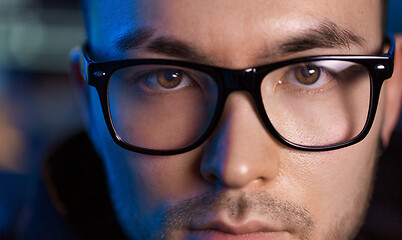 Image showing close up of asian male hacker\'s face in glasses