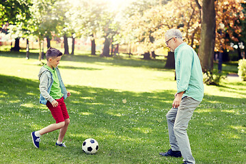 Image showing old man and boy playing football at summer park