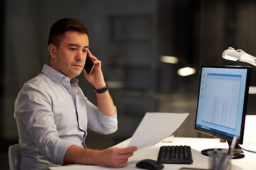 Image showing businessman calling on sartphone at night office