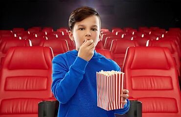 Image showing boy in blue hoodie eating popcorn at movie theater