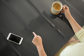 Image showing woman with coffee using black interactive panel