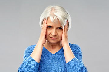 Image showing senior woman suffering from headache