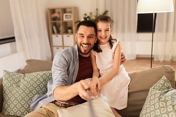 Image showing father and daughter taking selfie at home