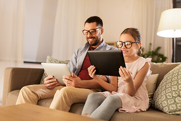 Image showing father and daughter with tablet computers at home