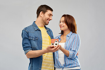 Image showing smiling couple holding house model