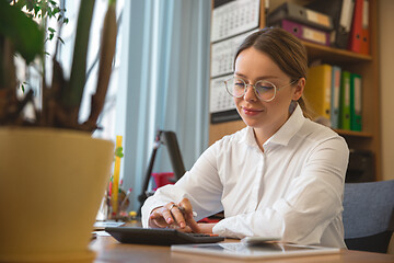 Image showing Caucasian entrepreneur, businesswoman, manager working concentrated in office