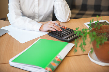 Image showing Caucasian entrepreneur, businesswoman, manager working concentrated in office, close up, focus on hands