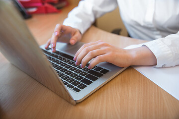 Image showing Caucasian entrepreneur, businesswoman, manager working concentrated in office, close up, focus on hands