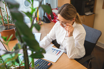 Image showing Caucasian entrepreneur, businesswoman, manager working concentrated in office