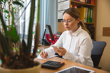 Image showing Caucasian entrepreneur, businesswoman, manager working concentrated in office