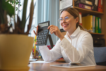 Image showing Caucasian entrepreneur, businesswoman, manager working concentrated in office, successful