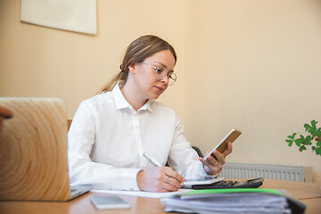 Image showing Caucasian entrepreneur, businesswoman, manager working concentrated in office